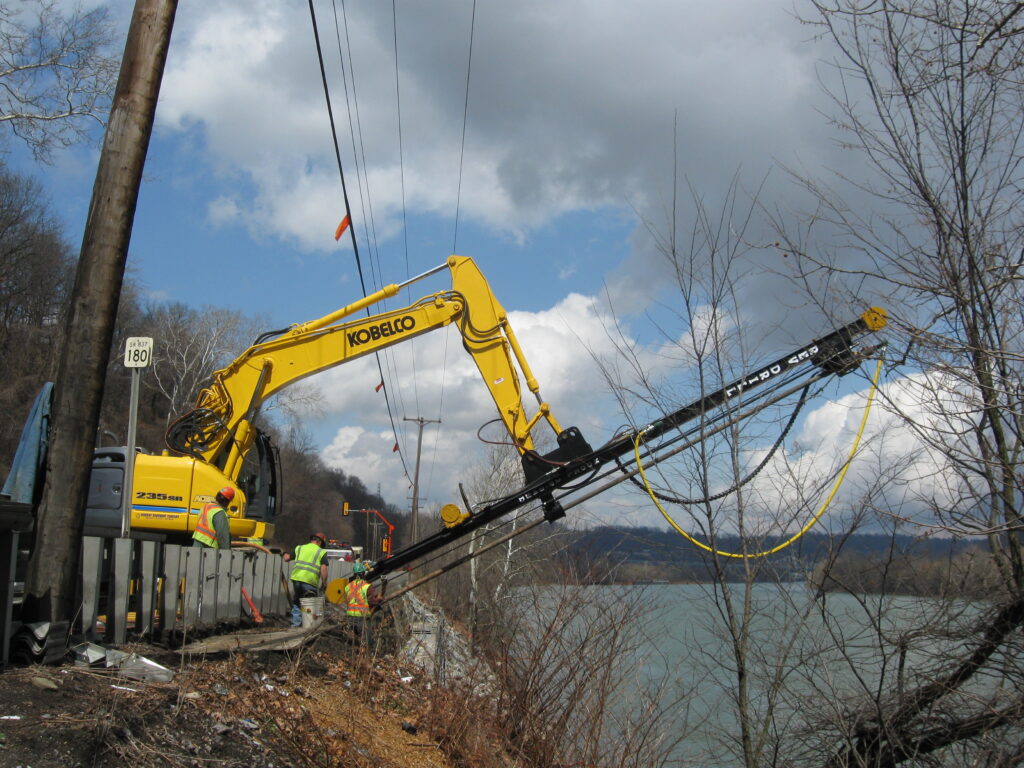 REV Drill custom bit working at an angle for roadside construction next to river bank