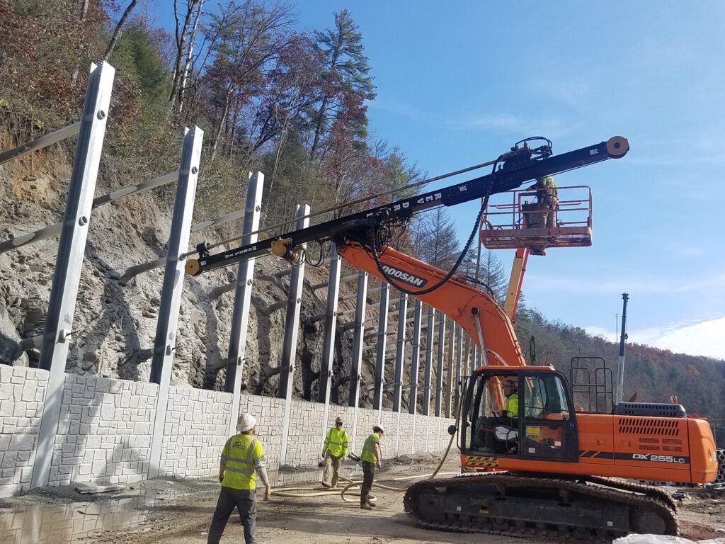REV Drill working on roadside wall for heavy civil work