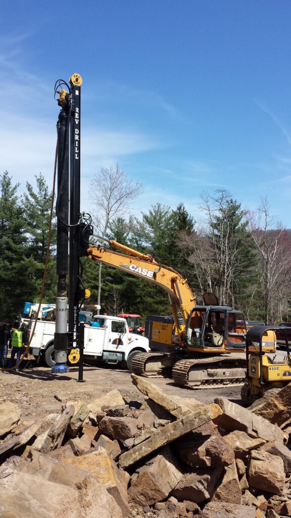 REV Drill getting ready to dig into rock to level out a field