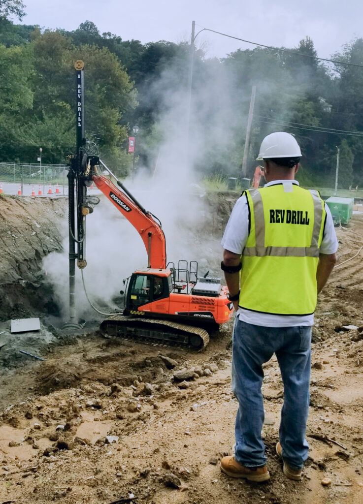 Operator running a REV Drill on an urban jobsite